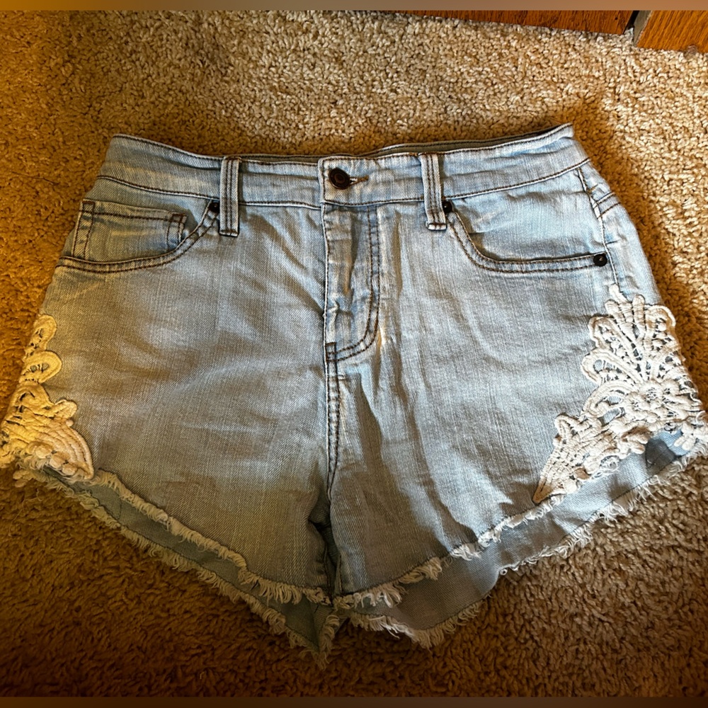Jean shorts with white lace on both sides size 4.